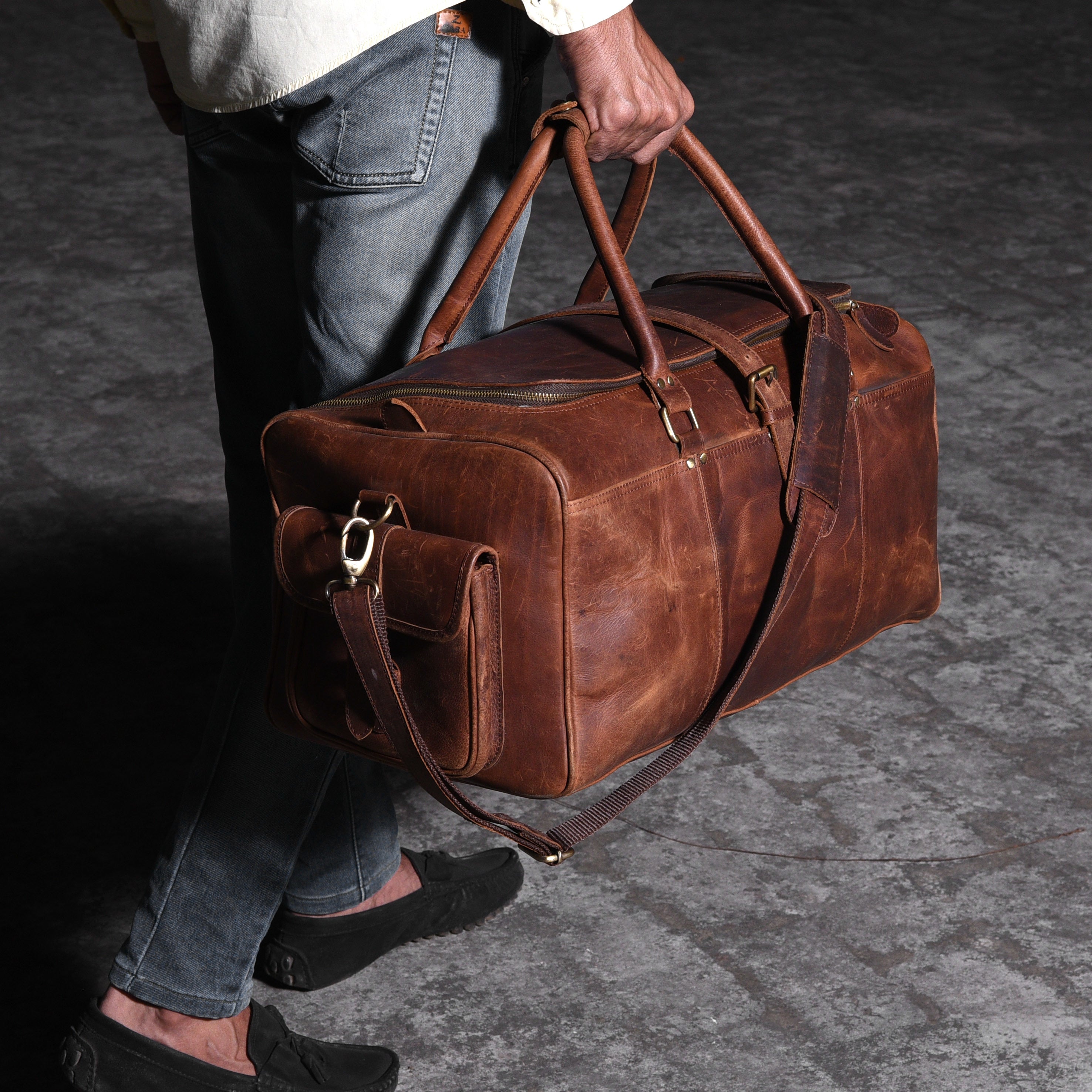 man-walking-with-a-leather-travel-bag.jpg